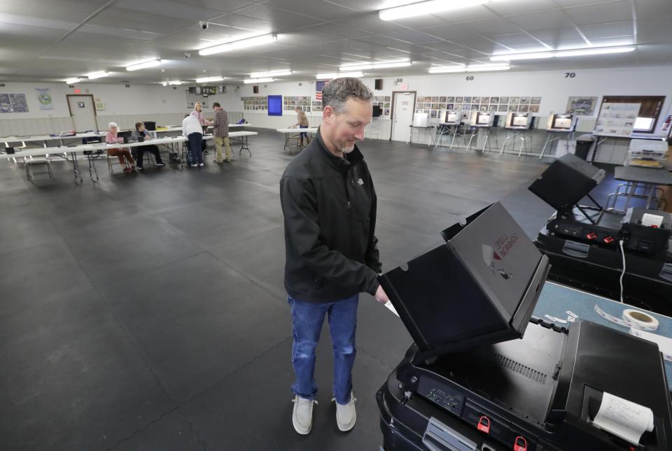 Nick Zwach casts his ballot Tuesday at the Winnegamie Dog Club on Manitowoc Road in Menasha.