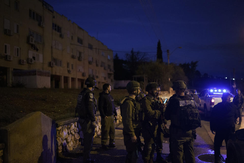 Israeli security forces stand in a neighborhood that was hit by a rocket fired from Lebanon, in Kiryat Shmona, northern Israel, Thursday, Jan. 11, 2024. The prospect of a full-scale war between Israel and Lebanon’s Hezbollah militia terrifies people on both sides of the border, but some see it as an inevitable fallout from Israel’s ongoing war against Hamas in Gaza. (AP Photo/Leo Correa)