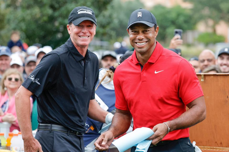 Dec 17, 2023; Orlando, Florida, USA; Tiger Woods (right) and Steve Stricker grab green sheets on the first tee during the PNC Championship at The Ritz-Carlton Golf Club. Mandatory Credit: Reinhold Matay-USA TODAY Sports