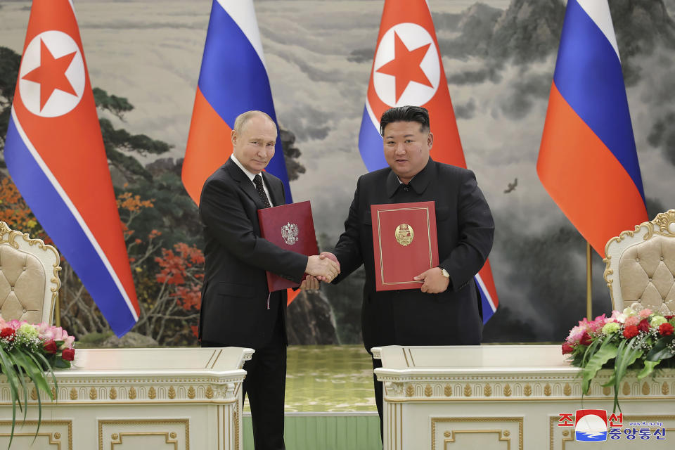 In this photo provided by the North Korean government, North Korean leader Kim Jong Un, right, and Russia's President Vladimir Putin shake hands after signing a comprehensive strategic partnership in Pyongyang, North Korea Wednesday, June 19, 2024. The content of this image is as provided and cannot be independently verified. Korean language watermark on image as provided by source reads: "KCNA" which is the abbreviation for Korean Central News Agency. (Korean Central News Agency/Korea News Service via AP)