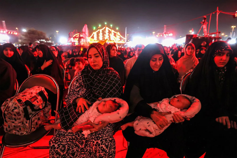 Families attend the "Moharram Shahr" exhibition at Azadi Square in Tehran on August 13, 2024.  (Atta Kenare / AFP - Getty Images)