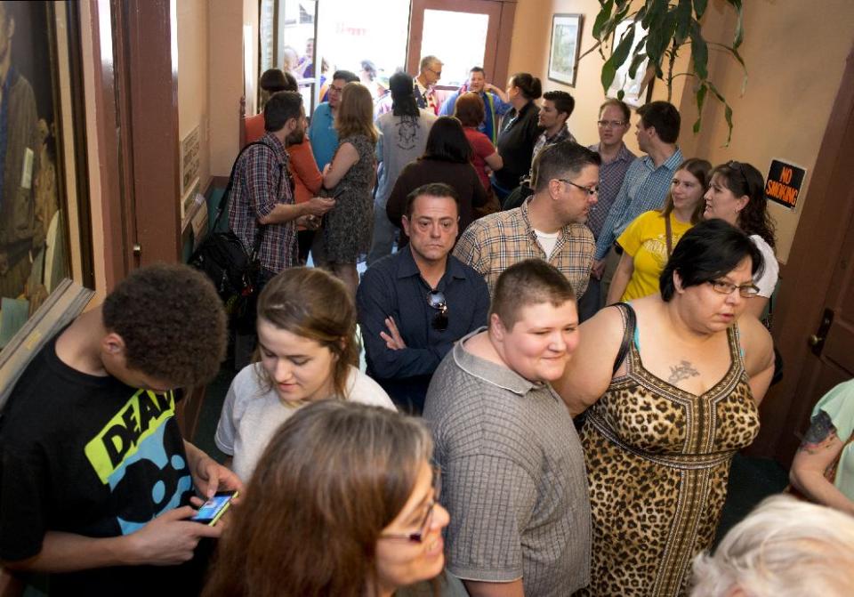 A crowd gathers inside the Carroll County Courthouse to apply for a marriage license in Eureka Springs, Ark., Saturday, May 10, 2014. A judge overturned amendment 83 on Friday, which banned same-sex marriage in the state of Arkansas. (AP Photo/Sarah Bentham)