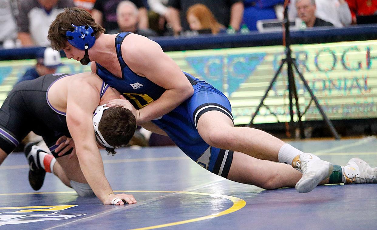 Ontario’s Landon Campbell wrestles Columbus DeSales’ Max Shulaw in the 215-pound final at the district tournament Saturday in Norwalk.