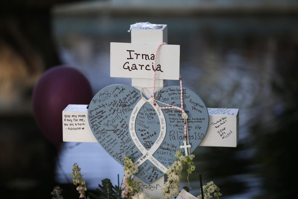 Irma Garcia's cross stands at a memorial site for the victims killed in this week's shooting at Robb Elementary School in Uvalde, Texas, Friday, May 27, 2022. (AP Photo/Dario Lopez-Mills)
