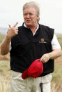 <p>A windswept Trump views developments to his luxury golf resort during a visit to Menie estate in Aberdeenshire, Scotland, on June 20, 2011. <i>(Photo: Danny Lawson/AP)</i> </p>