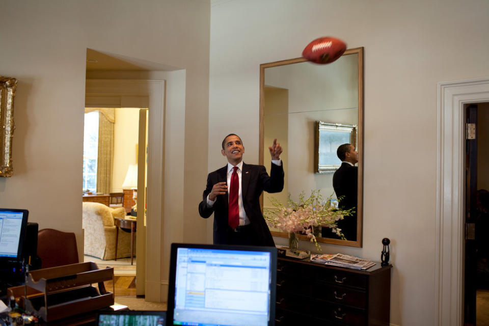 Obama plays with a football in the Outer Oval Office on March 4, 2009.