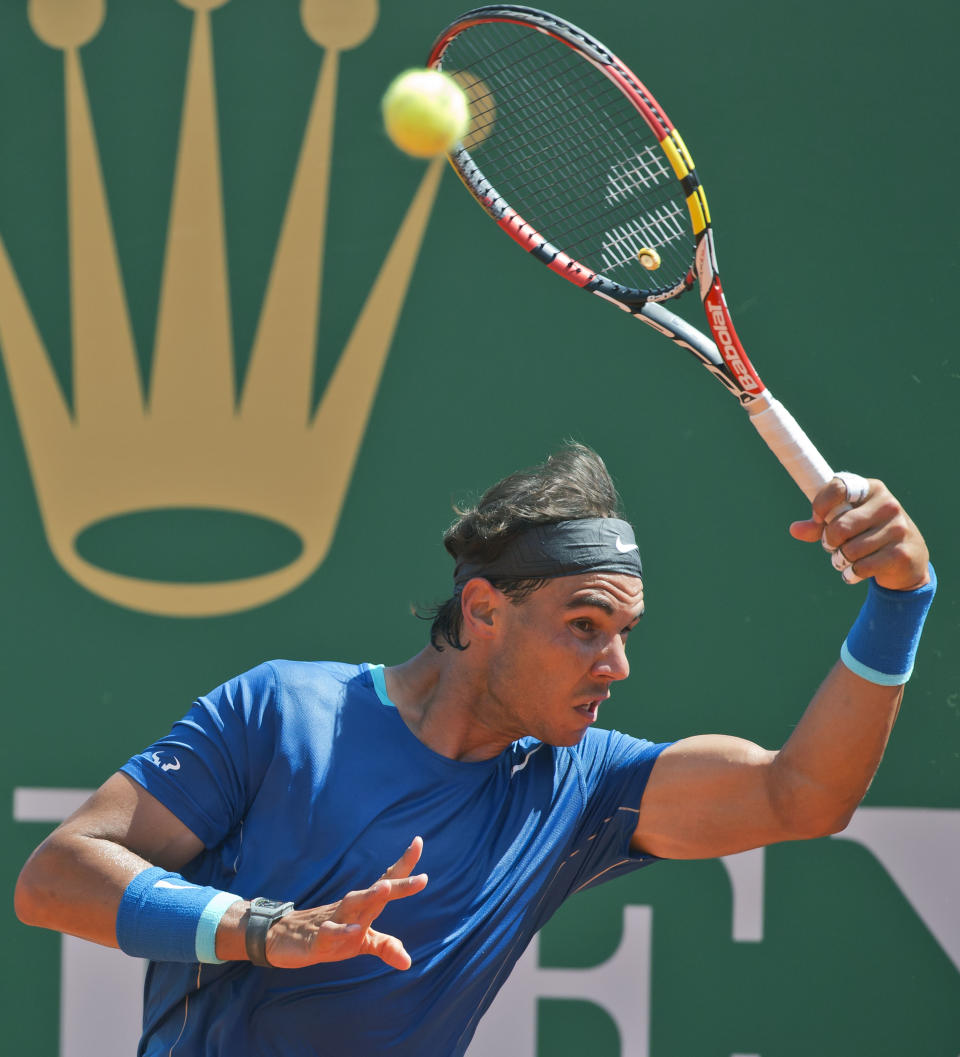 Rafael Nadal of Spain, returns the ball to Andreas Seppi of Italy, during their third round match of the Monte Carlo Tennis Masters tournament in Monaco, Thursday, April 17, 2014. Nadal won 6-1 6-3. (AP Photo/Michel Euler)