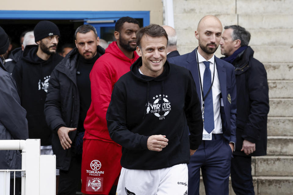 French President Emmanuel Macron arrives to participate in the Varietes Club charity football match to benefit children in hospital, at the Bernard Giroux stadium in Plaisir, outside Paris, Wednesday, April 24, 2024. (Benoit Tessier/Pool via AP)