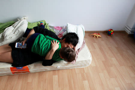 Romania-Roma actress Mihaela Dragan hugs her nephew during a visit to her sister's house, in Constanta, Romania, December 6, 2017. REUTERS/Andreea Campeanu