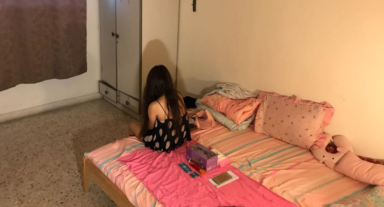 A woman caught during a vice raid conducted by the Singapore Police Force on vice activities in the heartland. Photo: Hannah Teoh/Yahoo News Singapore