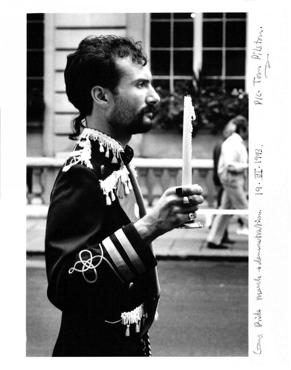 Man holding a candle on the Gay Pride march in London, 1993. To buy this print, click here (Tom Pilston/The Independent)