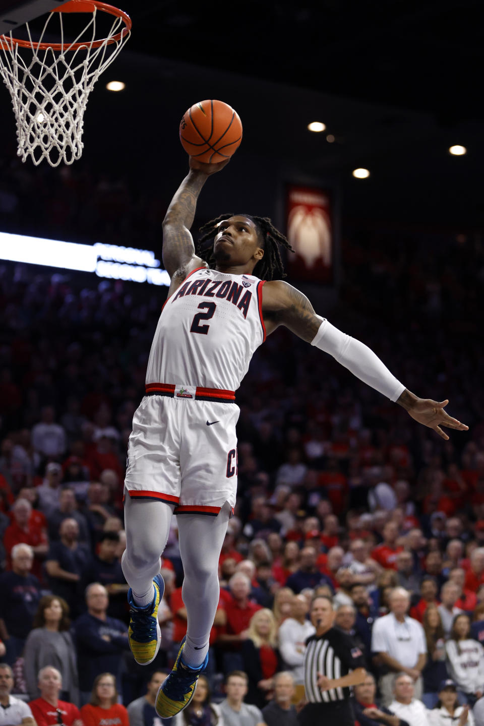 Arizona guard Caleb Love dunks during the second half of an NCAA college basketball game against Colgate, Saturday, Dec. 2, 2023, in Tucson, Ariz. (AP Photo/Chris Coduto)