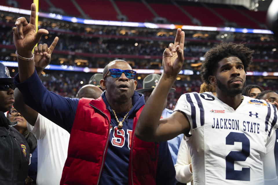 FILE - Then-Jackson State head coach Deion Sanders, left, and his son then-Jackson State quarterback Shedeur Sanders sing the school's alma mater after the Celebration Bowl NCAA college football game against North Carolina Central, Saturday, Dec. 17, 2022, in Atlanta. Deion Sanders is now head coach at Colorado and Shedeur Sanders now plays for Colorado. Colorado opens their season at TCU on Sept. 2. (AP Photo/Hakim Wright Sr., File)