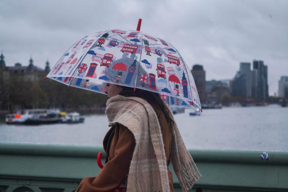 London, UK. 14 November 2023. Pedestrians with umbrellas on Westminster Bridge during heavy rain showers . The Met Office has issued  a yellow weather warning for thunderstorms, heavy rain and severe gale-force winds across London and southern England, as Storm Debi hits parts of the UK..Credit: amer ghazzal/Alamy Live News