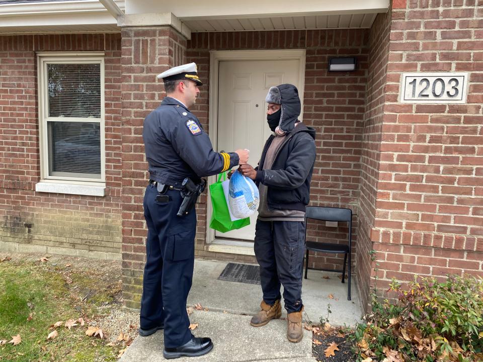 Columbus police officers distributed Thanksgiving meals to hundreds of Rosewind Apartments residents on Wednesday during the annual "Cops and Gobblers" food donation event.