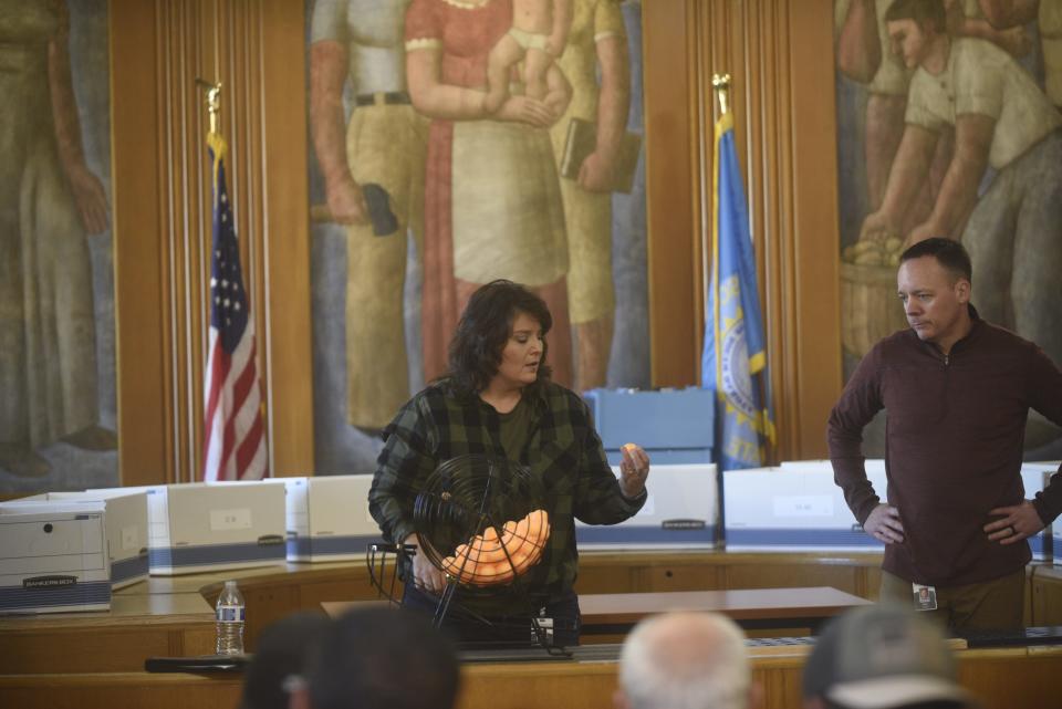 Purchasing Manager Scott Rust looks on as Licensing Specialist Jamie Palmer draws the first ball in the city's lottery for medical marijuana dispensary licenses