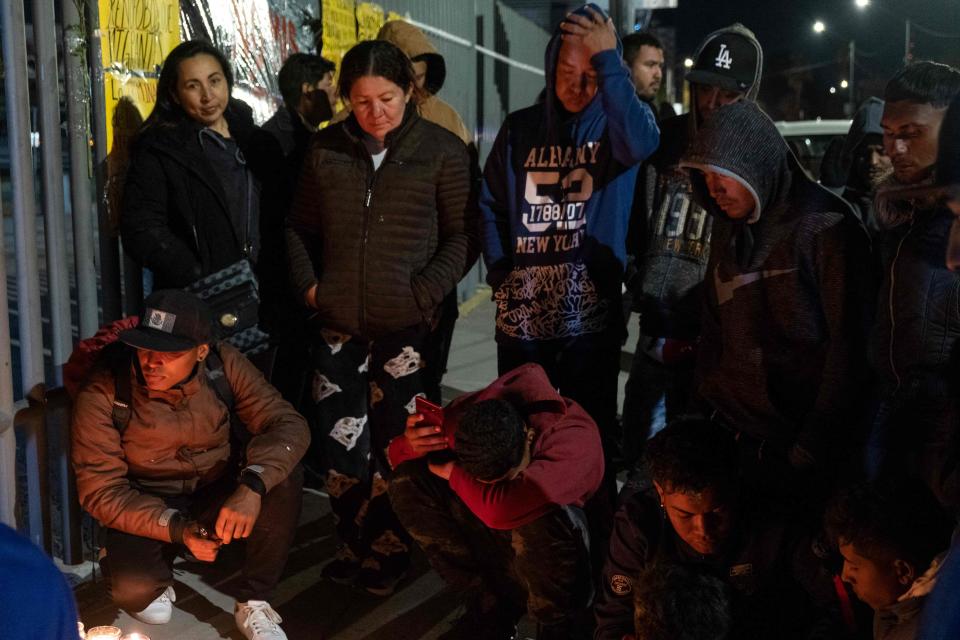 Migrants take part in a vigil on March 28, 2023, in Ciudad Juarez, Mexico, for migrants who died in a fire at an immigration detention center. The fire broke out when migrants fearing deportation set mattresses ablaze, Mexican President Andrés Manuel López Obrador said.