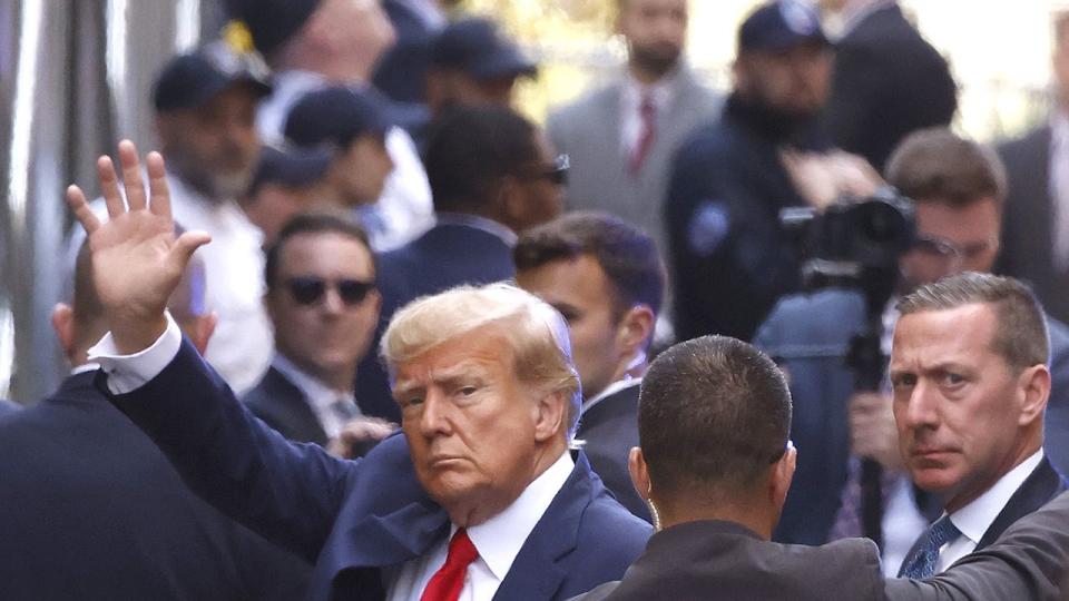 Former President Donald Trump waves as he arrives at the Manhattan Criminal Court on April 4, 2023 in New York City. Trump will be arraigned during his first court appearance today following an indictment by a grand jury that heard evidence about money paid to adult film star Stormy Daniels before the 2016 presidential election. With the indictment, Trump becomes the first former U.S. president in history to be charged with a criminal offense.