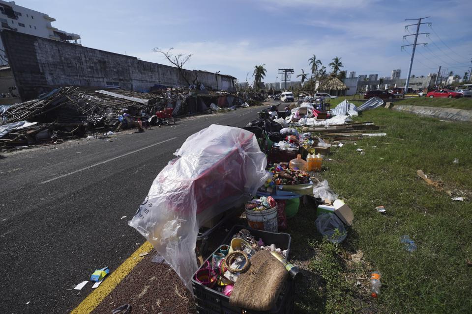 Recovered goods and debris line a road two days after the passage of Hurricane Otis hit as a Category 5 storm in Acapulco, Mexico Friday, Oct. 27, 2023. (AP Photo/Marco Ugarte)