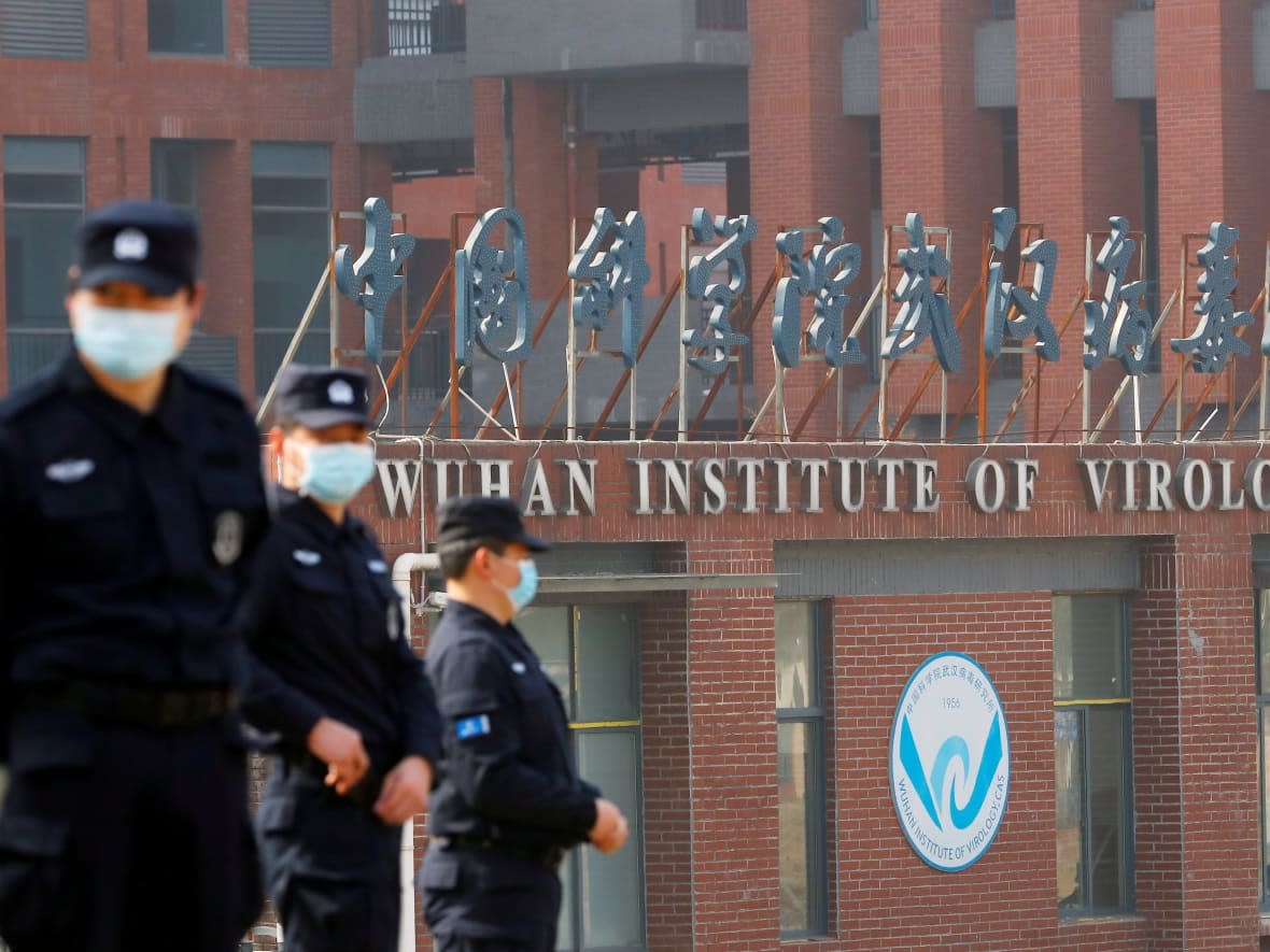 Security personnel keep watch outside the Wuhan Institute of Virology during the visit by the World Health Organization team in Feb. that was tasked with investigating the origins of COVID-19, in Wuhan, Hubei province, China. Last week, the WHO announced it had formed a new advisory group to try to determine source of the virus. (Thomas Peter/Reuters - image credit)