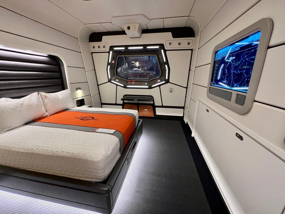 star wars starcruiser cabin with white walls, lights under bed, dark floors