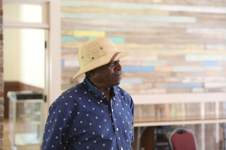 Ralph James stands in the auditorium of the restored Rosenwald School he attended as a child in St. George, S.C., Tuesday, July 11, 2023. The 76-year-old retired municipal judge has made it his life's goal to restore his old school. In the past decade, James has secured more than $2 million in grants, money from the state and gifts from corporations and others. (AP Photo/Jeffrey Collins)