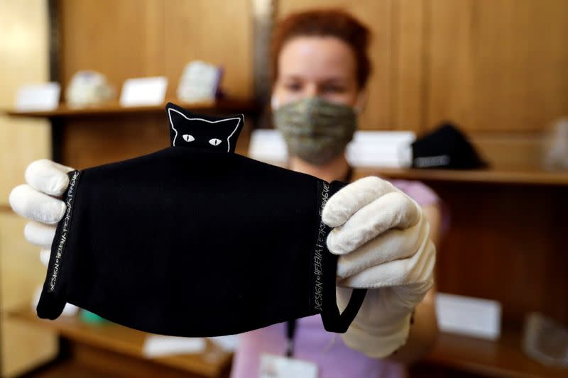 A worker prepares a face mask exhibition in Prague