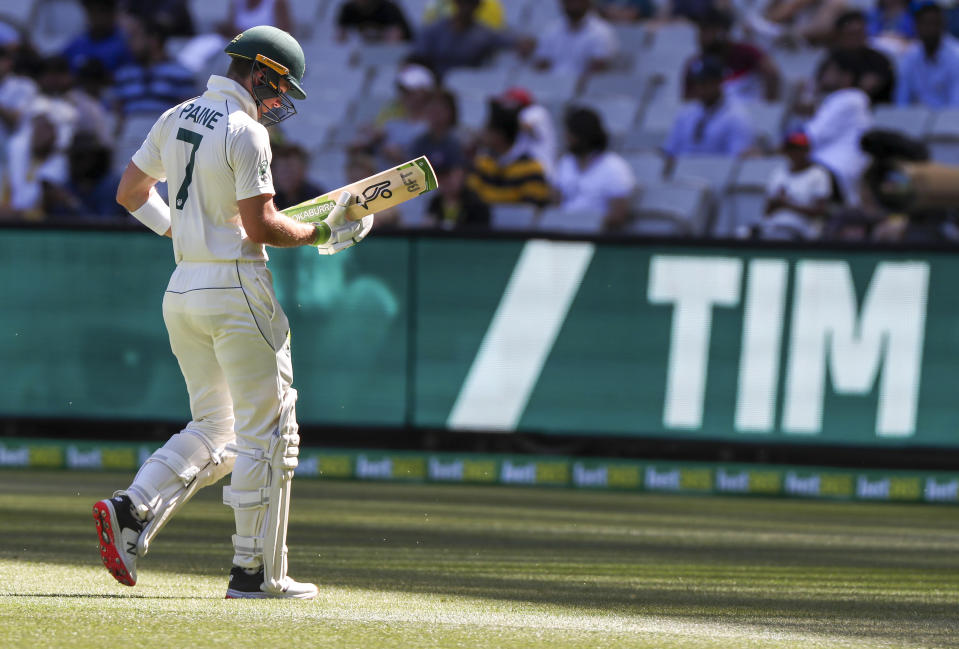 FILE - Australia's Tim Paine walks from the field after he was dismissed during play against India at the Melbourne Cricket Ground, in Melbourne, Australia on Dec. 26, 2020. Paine has quit as captain after admitting on Friday, Nov. 19, 2021, he sent explicit messages to a female co-worker. (AP Photo/Asanka Brendon Ratnayake, File)