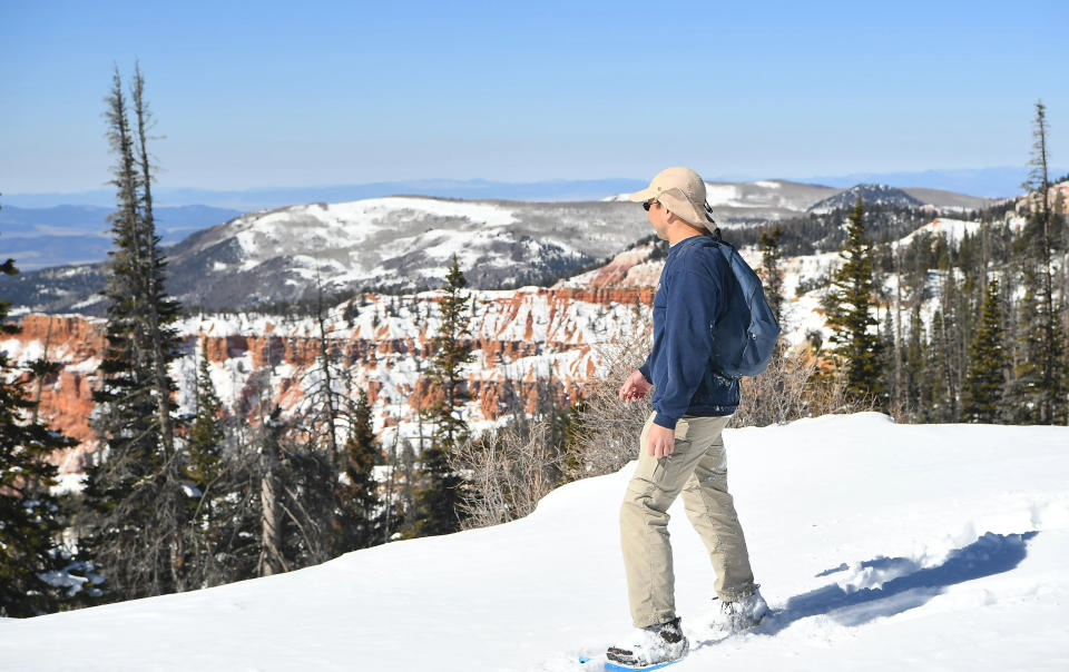 A hiker looks out over a snow Cedar Breaks National Monument in this Spectrum file photo.