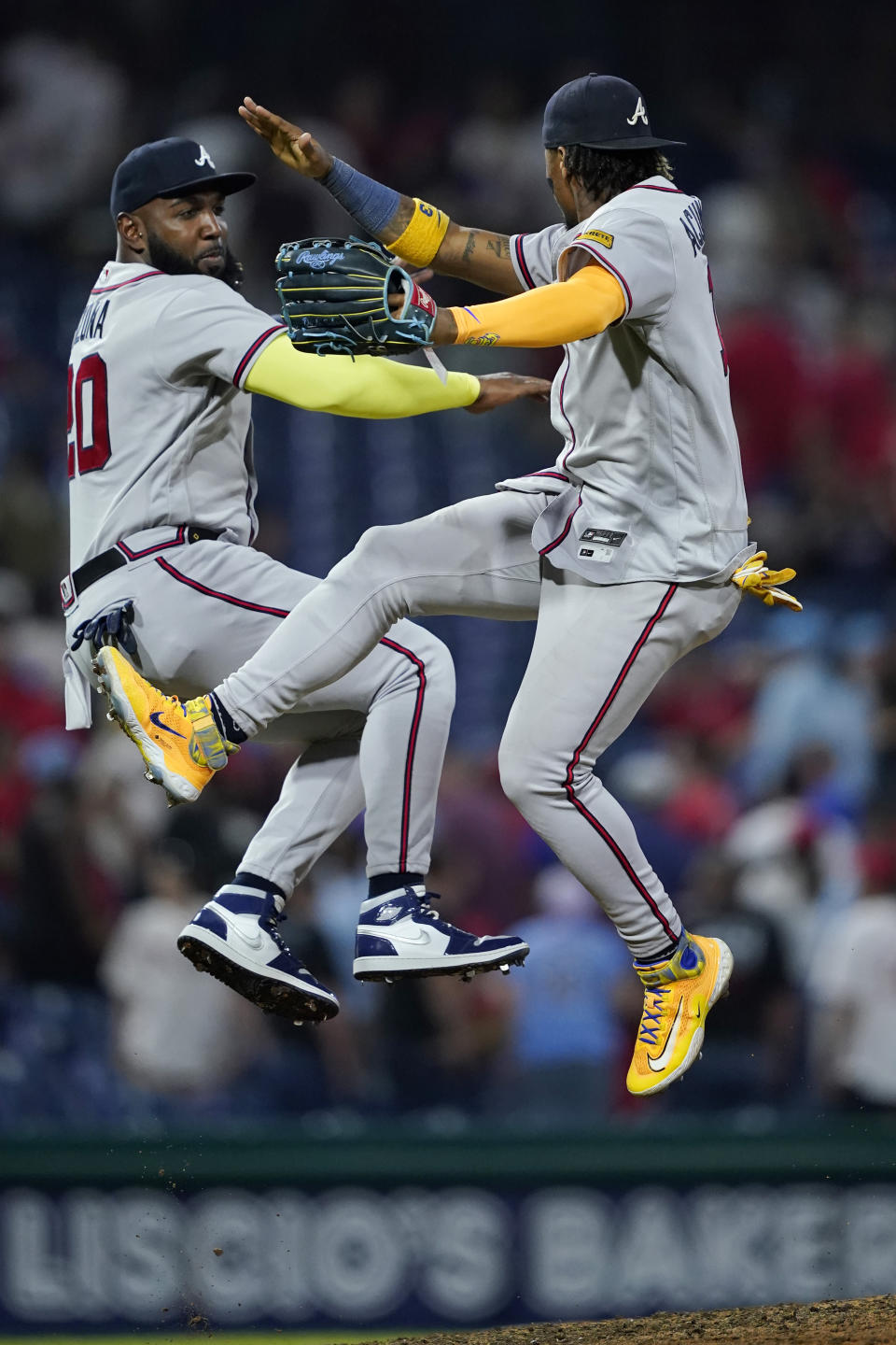 Atlanta Braves' Marcell Ozuna, left, and Ronald Acuna Jr. celebrate after the Braves won a baseball game against the Philadelphia Phillies, Tuesday, Sept. 12, 2023, in Philadelphia. (AP Photo/Matt Slocum)