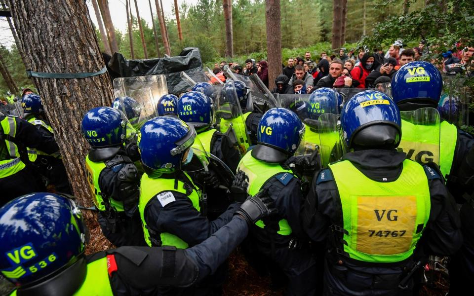 Police attempt to break up a suspected illegal rave, in Thetford Forest, in Norfolk - Toby Melville/REUTERS