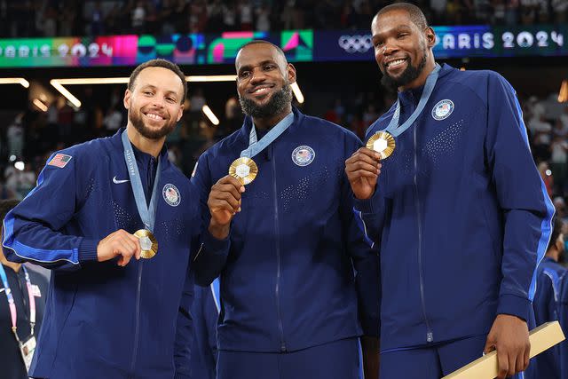 <p>Gregory Shamus/Getty</p> Stephen Curry, Lebron James, and Kevin Durant of Team United States pose for a photo during the Men's basketball medal ceremony on day fifteen of the Olympic Games Paris 2024