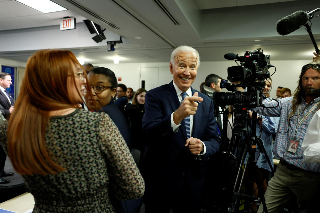 U.S. President Joe Biden laughs at the Democratic National Committee Headquarters ahead of the U.S. mid-term elections, in Washington, U.S., October 24, 2022. REUTERS/Evelyn Hockstein