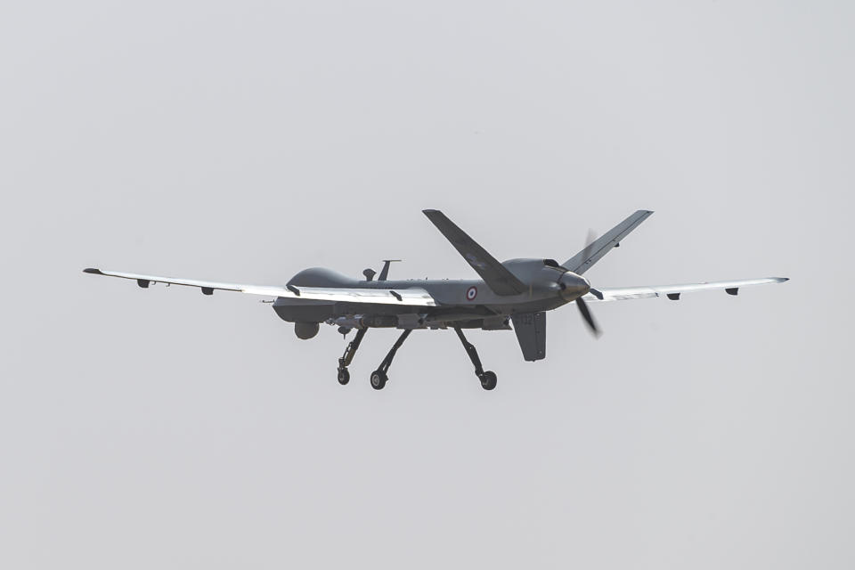 This photo provided by the French Defense Ministry communication center and taken Tuesday Dec. 17, 2019, shows a French Reaper drone with two GBU 12 missiles flying over Niamey airbase, Niger. France's defense ministry said Monday that it had carried out its first armed drone strike, killing seven Islamic extremists in central Mali over the weekend. France joins a tiny group of countries that use armed drones, including the United States. (Malaury Buis/EMA/DICOD via AP)