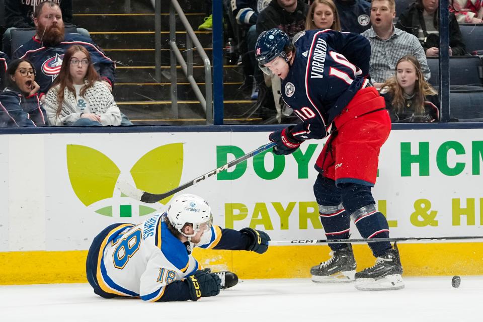 Dec 8, 2023; Columbus, Ohio, USA; Columbus Blue Jackets left wing Dmitri Voronkov (10) knocks St. Louis Blues center Robert Thomas (18) to the ice during the first period of the NHL game at Nationwide Arena.