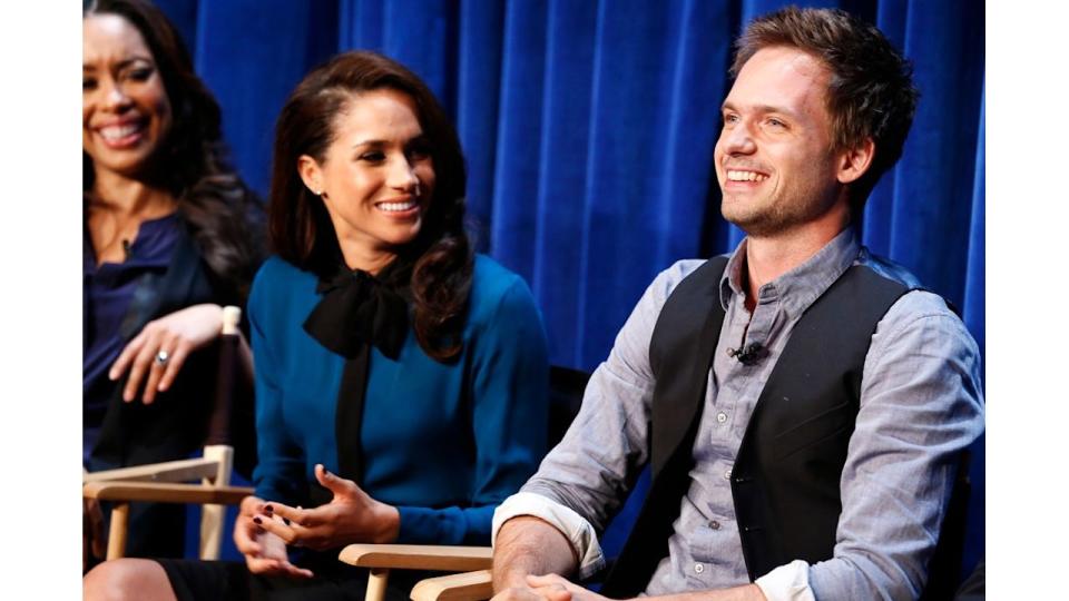 Meghan Markle smiling at Patrick J. Adams 