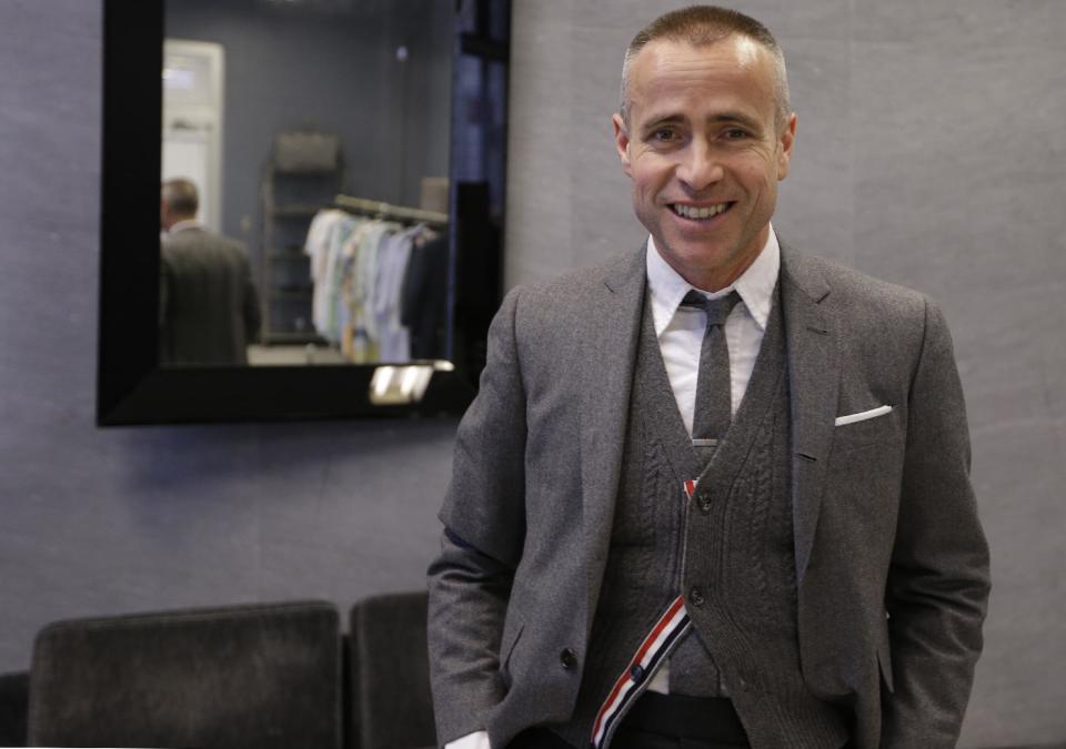 Fashion designer Thom Browne poses for a photograph at his Hudson Street store in New York, Wednesday, Feb. 20, 2013. Browne is building a business _ and what he hopes is a smart, long-lasting business at that. He's just not the overzealous, mercurial artiste. (AP Photo/Kathy Willens)