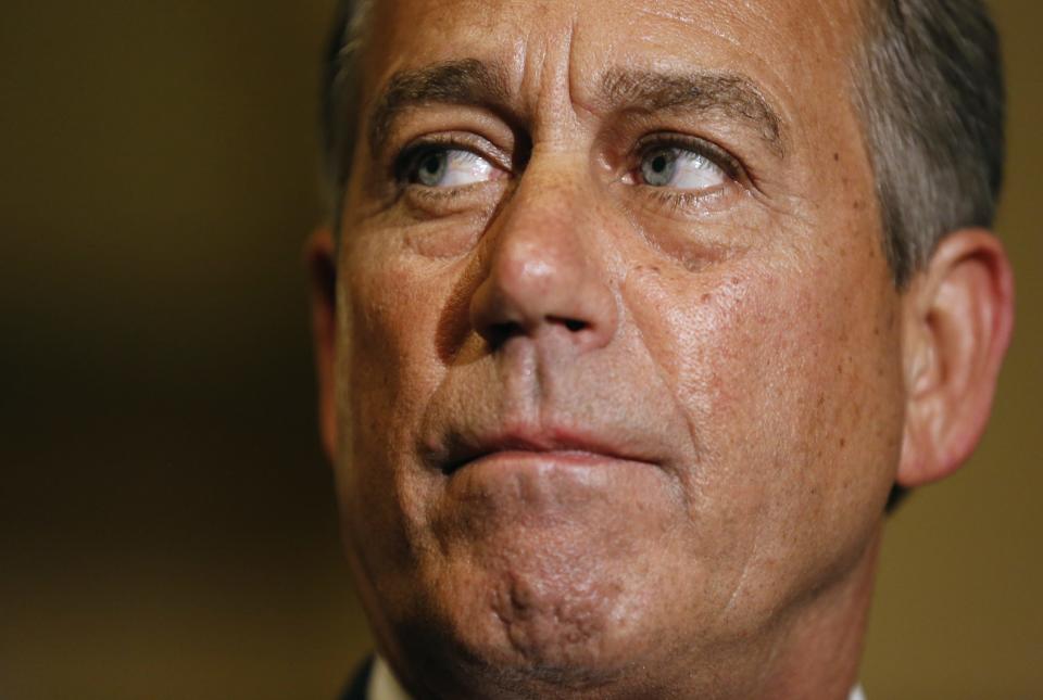 Speaker of the House John Boehner pauses as he speaks to the media at 1:00 am immediately after the House of Representatives voted to send their funding bill with delays to the "Obamacare" health care act into a conference with the Senate, prompting a shutdown of portions of the U.S. government in Washington, October 1, 2013. The U.S. government began a partial shutdown on Tuesday for the first time in 17 years, potentially putting up to 1 million workers on unpaid leave, closing national parks and stalling medical research projects. REUTERS/Jim Bourg (UNITED STATES - Tags: POLITICS BUSINESS)