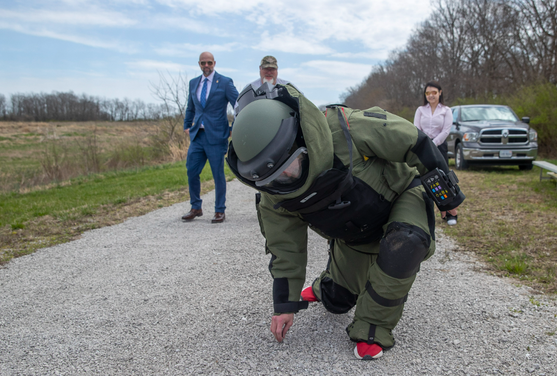 ATF Lexington field office employees look on as Herald-Leader service journalist Aaron Mudd attempts to pick something up from the ground while dressed in a bomb suit in Fayette County March 30, 2022.