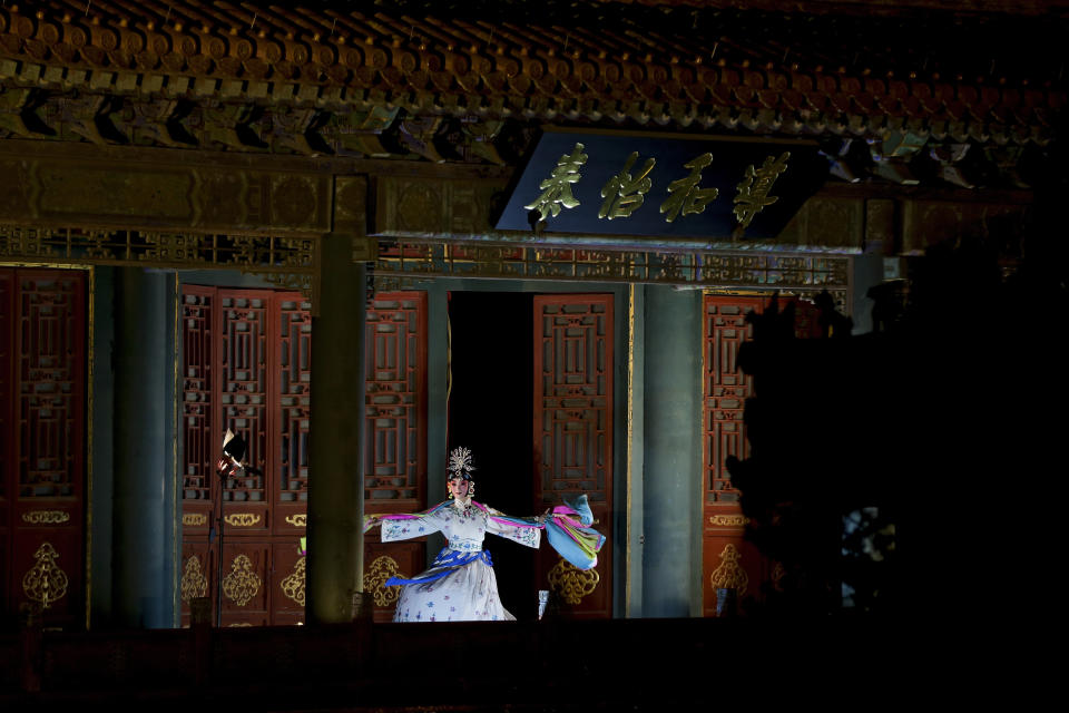 A Peking Opera artist performs dance in the Forbidden City which lit up by lights during the Lantern Festival in Beijing, Tuesday, Feb. 19, 2019. (Photo: Andy Wong/AP)