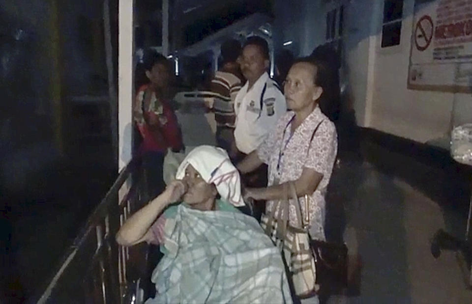 In this image made from video, patients are evacuated from a hospital following a strong earthquake in Poso, central Sulawesi, Indonesia, Friday, Sept. 28, 2018. A powerful earthquake has rocked the Indonesian island of Sulawesi and triggered a 1.5-meter (5-foot) tsunami that swept away houses in at least two cities. (AP Photo)