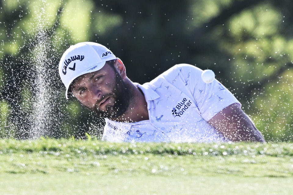 John Rahm of Spain hits out of the bunker on the 13th hole of the South Course during the third round of the Farmers Insurance Open golf tournament, Friday Jan. 28, 2022, in San Diego. (AP Photo/Denis Poroy)