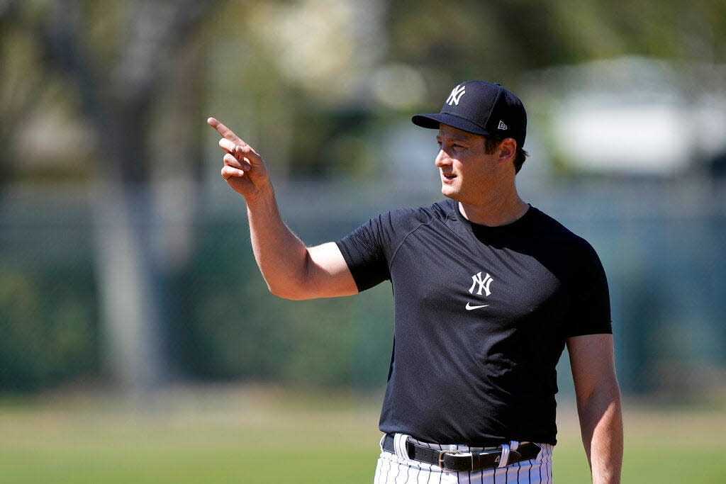 New York Yankees pitcher Gerrit Cole points to another field during a spring training baseball workout Saturday, Feb. 18, 2023, in Tampa, Fla. (AP Photo/David J. Phillip)