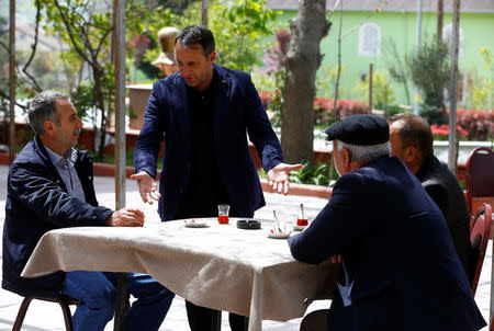 Oktay Teke, mukhtar of Sazlibosna, chats with villagers at a teahouse in Sazlibosna in Istanbul, Turkey, April 16, 2018. REUTERS/Osman Orsal