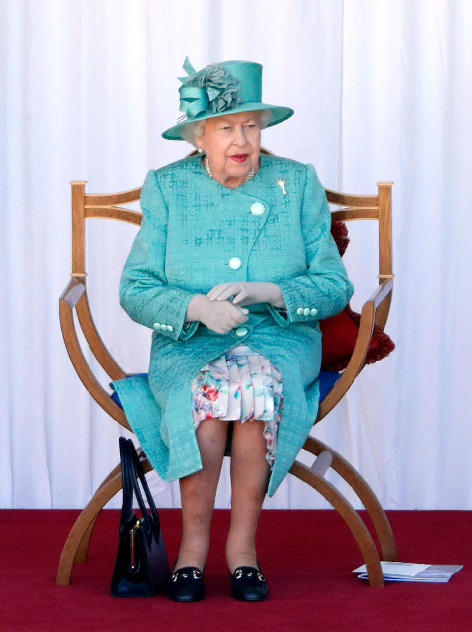 WINDSOR, UNITED KINGDOM - JUNE 13: (EMBARGOED FOR PUBLICATION IN UK NEWSPAPERS UNTIL 24 HOURS AFTER CREATE DATE AND TIME) Queen Elizabeth II attends a military ceremony in the Quadrangle of Windsor Castle to mark her Official Birthday on June 13, 2020 in Windsor, England. It was decided that due to the ongoing COVID-19 Pandemic The Queen's Birthday Parade, known as Trooping the Colour, would not go ahead in it's traditional form at Buckingham Palace and Horse Guards Parade, but a small military ceremony in line with the Government's Social Distancing Guidelines would take place at Windsor Castle instead. Soldiers of 1st Battalion Welsh Guards (whose Colour was due to be Trooped this year) will carry out a series of military drills and Royal Salute. (Photo by Max Mumby/Indigo/Getty Images)