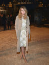 Suki Waterhouse in a floral beige dress with white flowers and khaki-colored coat represented Burberry in a classic, yet fresh, manner.