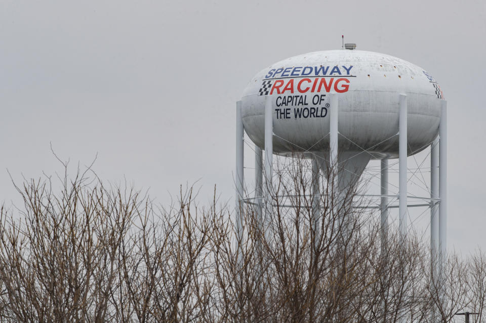 The water tower for the town of Speedway, Ind., proclaims itself the Racing Capital of the World outside the grounds of the Indianapolis Motor Speedway in Indianapolis, Saturday, March 28, 2020. Roger Penske, at 83 and considered high risk to the coronavirus as a 2017 kidney transplant recipient, still makes the daily three-minute commute to his Bloomfield Hills, Mich, office. He works 12 or more hours a day from his conference room at Penske Corp., which has a skeleton crew all practicing social distancing. Penske also had the small matter of planning his first Indianapolis 500. (AP Photo/Michael Conroy)