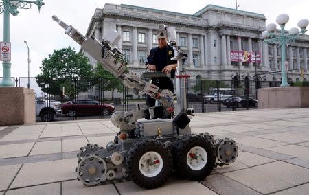 Cleveland police bomb squad technician Sgt. Tim Maffo-Judd demonstrates a Remotec F5A explosive ordnance device robot during a demonstration of police capabilities across the street from city hall near the site of the Republican National Convention in Cleveland, Ohio July 14, 2016. REUTERS/Rick Wilking