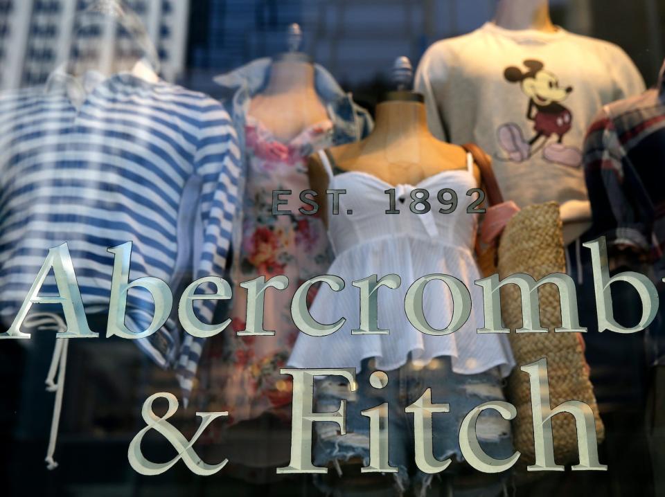 Mannequins wearing summer clothes are visible inside window of Abercrombie & Fitch store