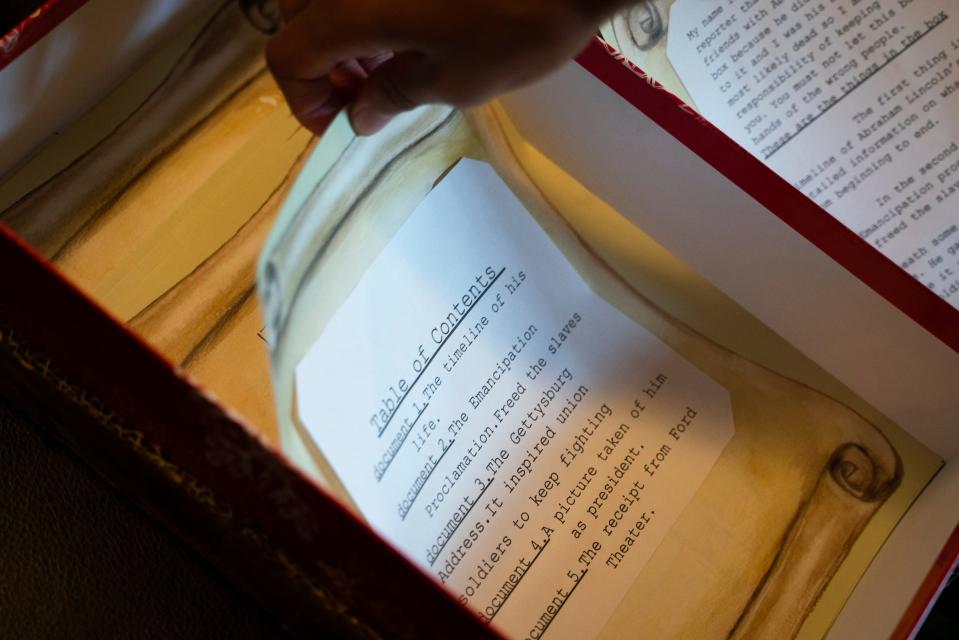 Max Maybee, 12, opens a box containing his 6th grade school project about the 16th U.S. President Abraham Lincoln at his home in Pleasant Ridge on Wednesday, July 12, 2023.